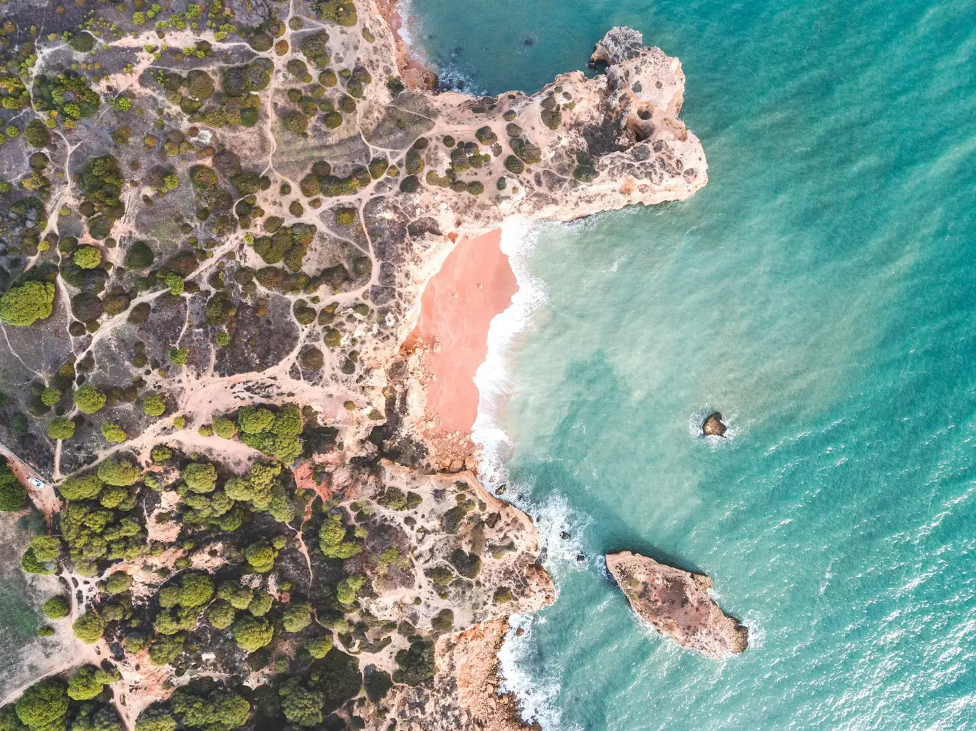 Stunning aerial view of the Faro coastline showcasing beaches and turquoise waters.