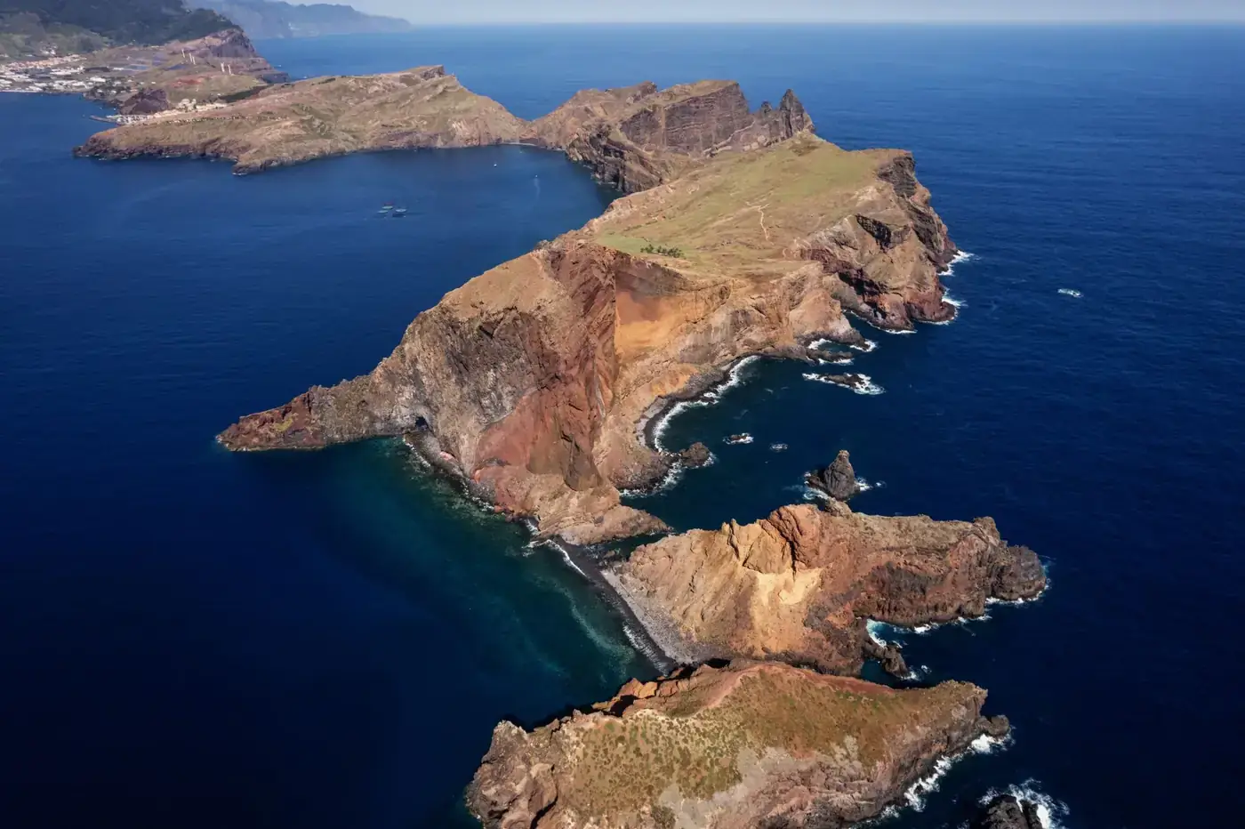 Stunning aerial shot of Madeira's dramatic coastline showcasing cliffs and azure ocean waters.