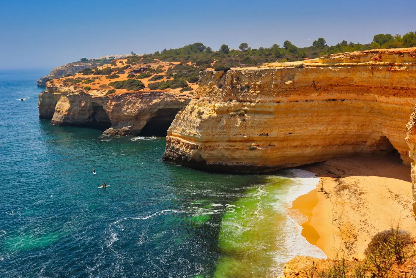 A breathtaking aerial view of Algarve cliffs and turquoise waters in Portugal's Praia de Corredoura.