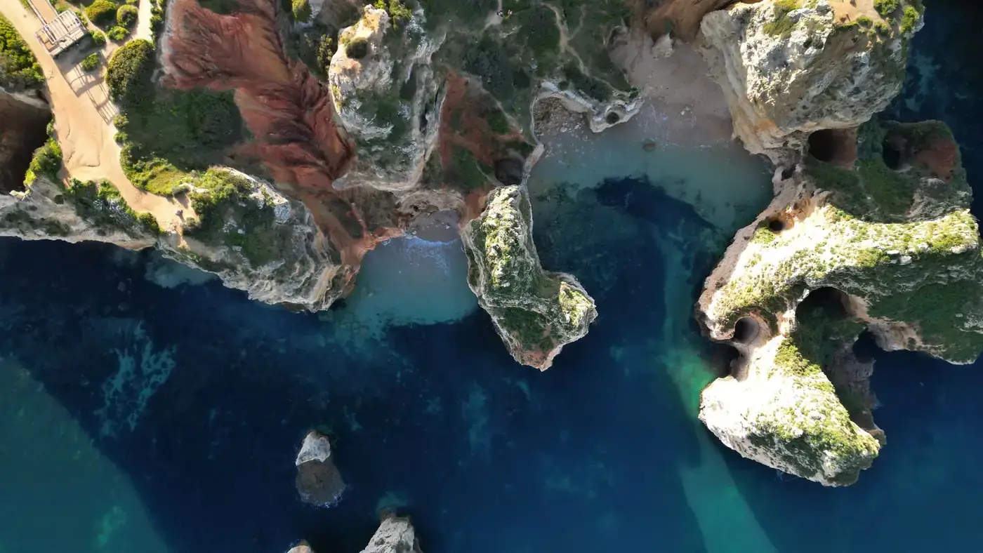 Stunning aerial shot of Algarve's coastal cliffs in Portugal's Distrito de Faro.