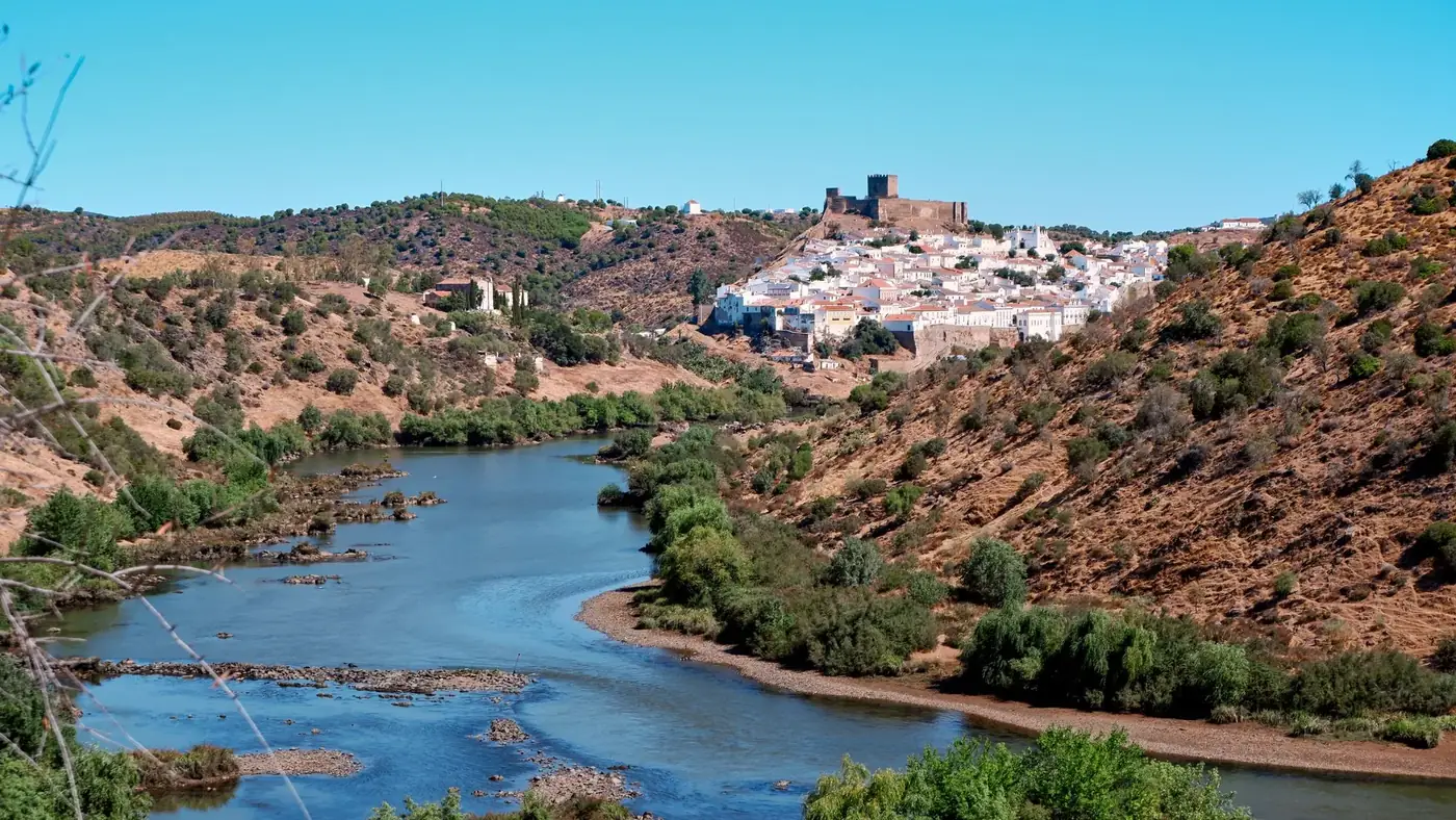 Discover the historic charm of Mértola with the Guadiana River's scenic bend.