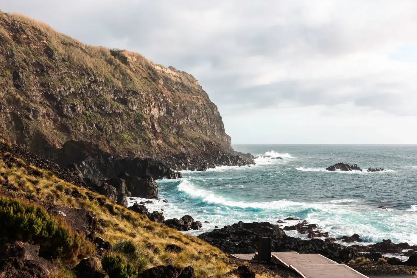 Stunning view of São Miguel Island cliffs with crashing waves along the rocky Azores shoreline.