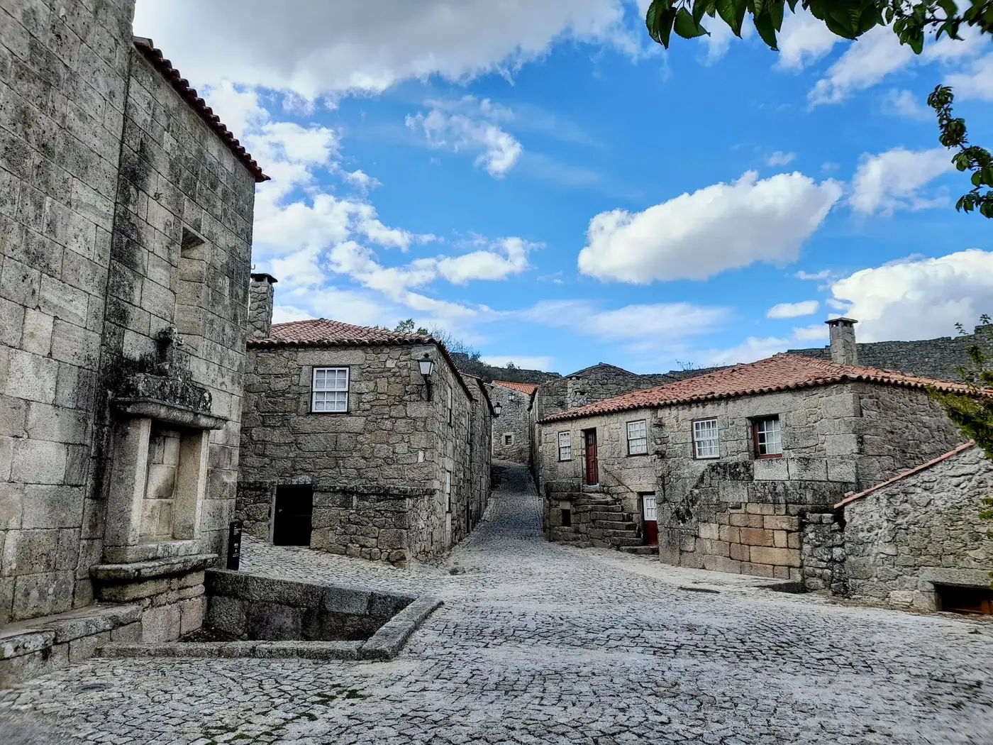 Historic cobblestone streets and stone houses in Sortelha, Portugal, showcasing traditional architecture.