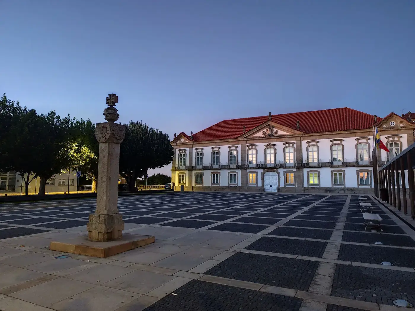 A serene view of a historic building and plaza in Seia, Portugal at dusk.