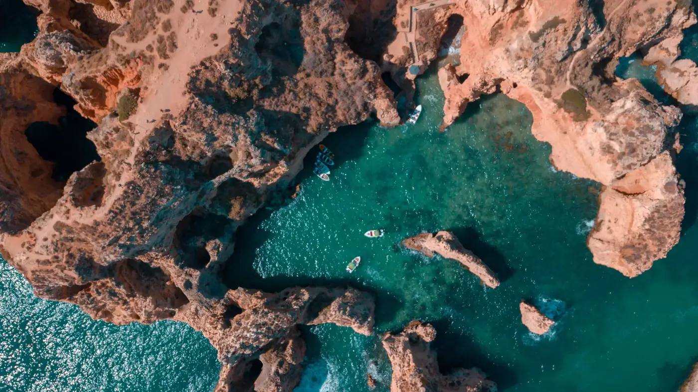 Aerial view of the stunning cliffs and coastline of Algarve, Portugal, with crystal clear sea water.