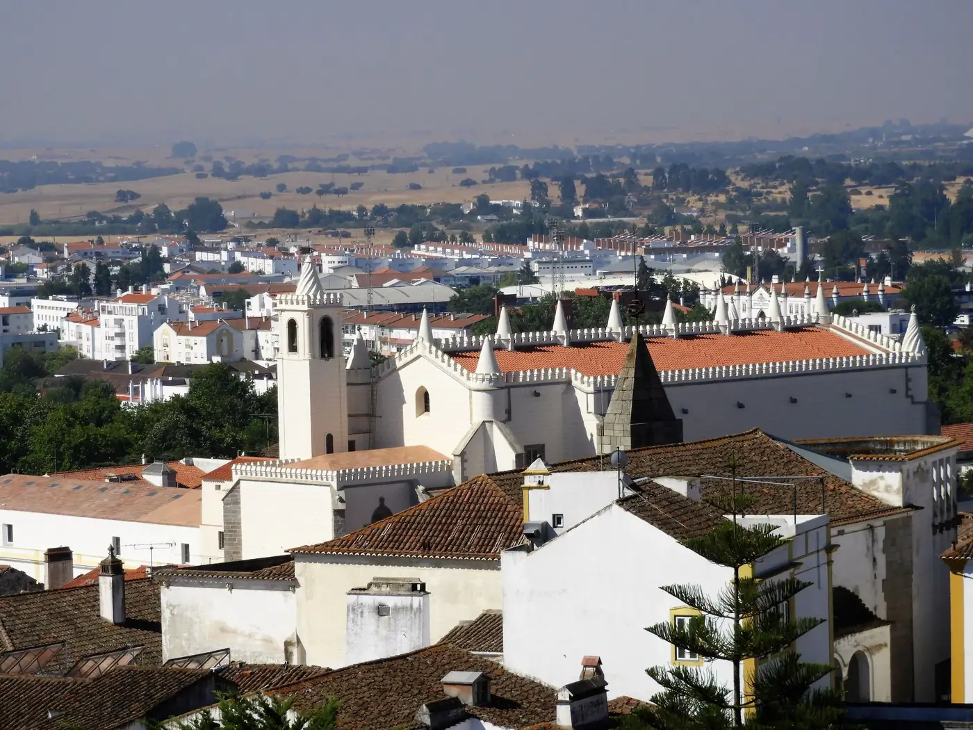 Stunning aerial view of Évora, showcasing historic architecture surrounded by a beautiful landscape.