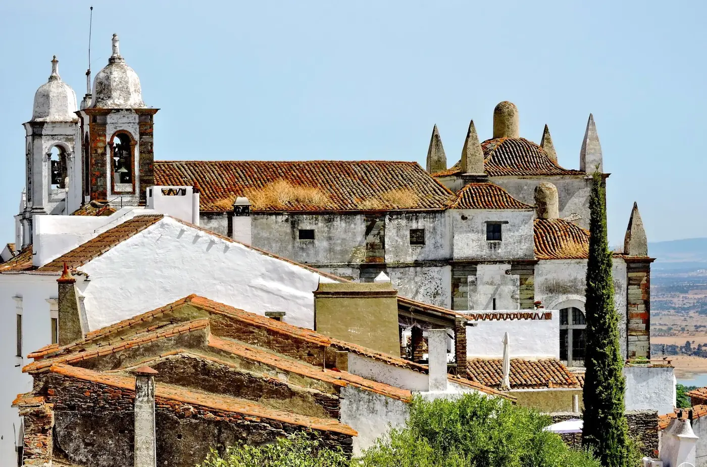 View of the historic Monsaraz Castle with scenic surroundings in Portugal's Alentejo region.