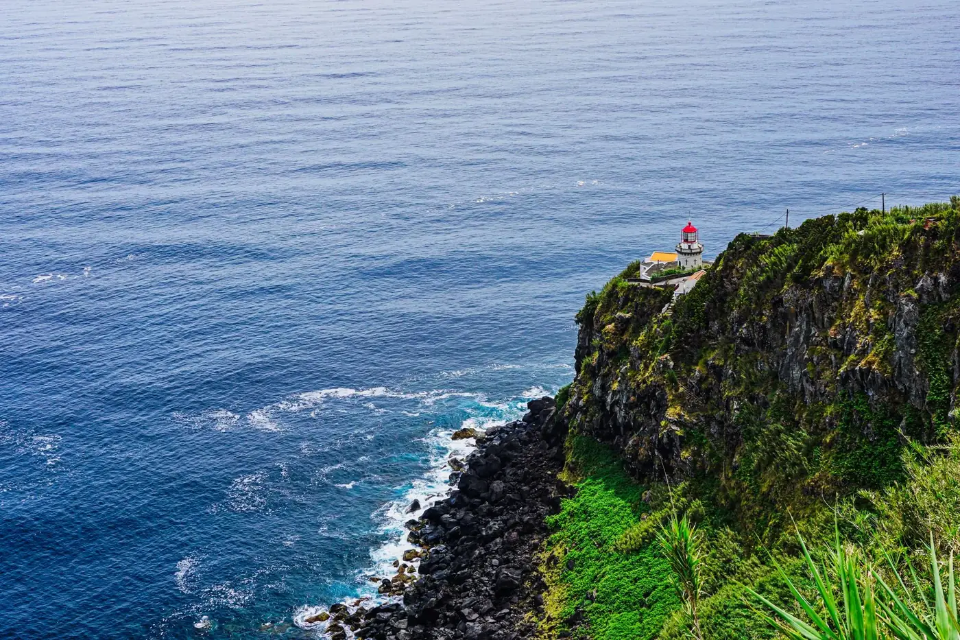 Stunning view of São Miguel Island cliffs with crashing waves along the rocky Azores shoreline.