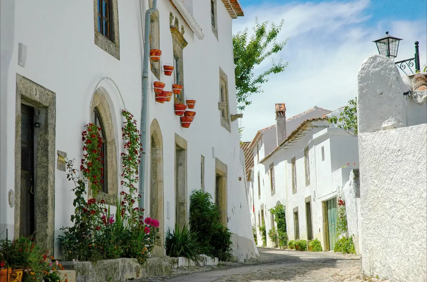 Explore the scenic whitewashed architecture of Marvão, Portugal, showcasing traditional cobblestone streets and historic