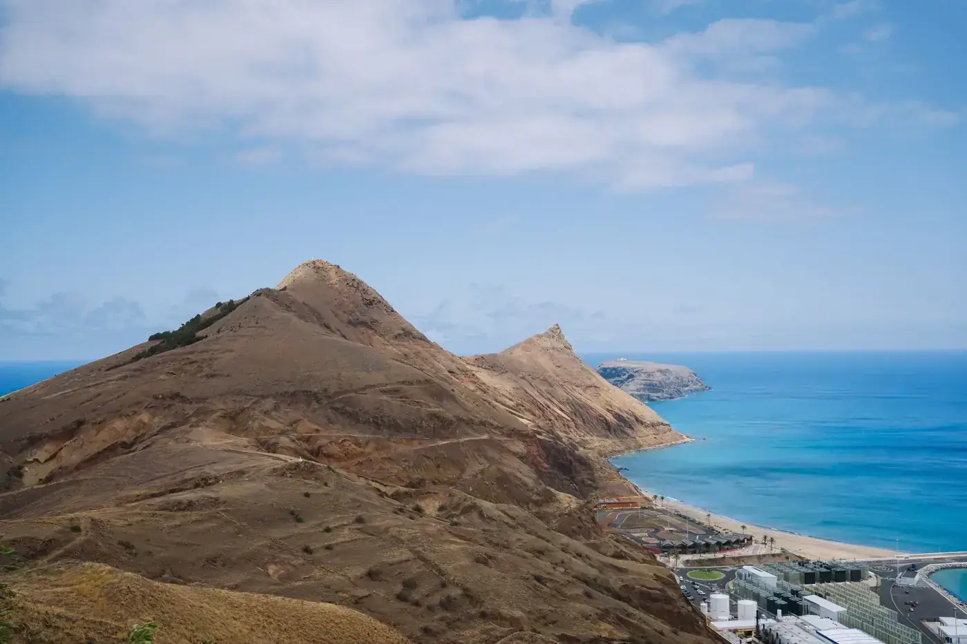 Dramatic landscape of a volcanic island with rugged cliffs overlooking the azure ocean waters, perfect for travel enthus