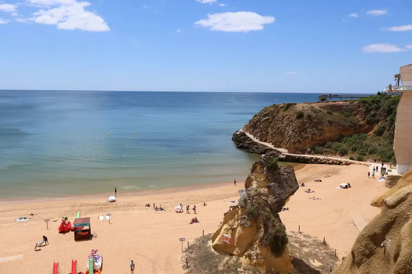 Scenic view of Praia da Rocha beach with cliffs and ocean in Algarve, Portugal.