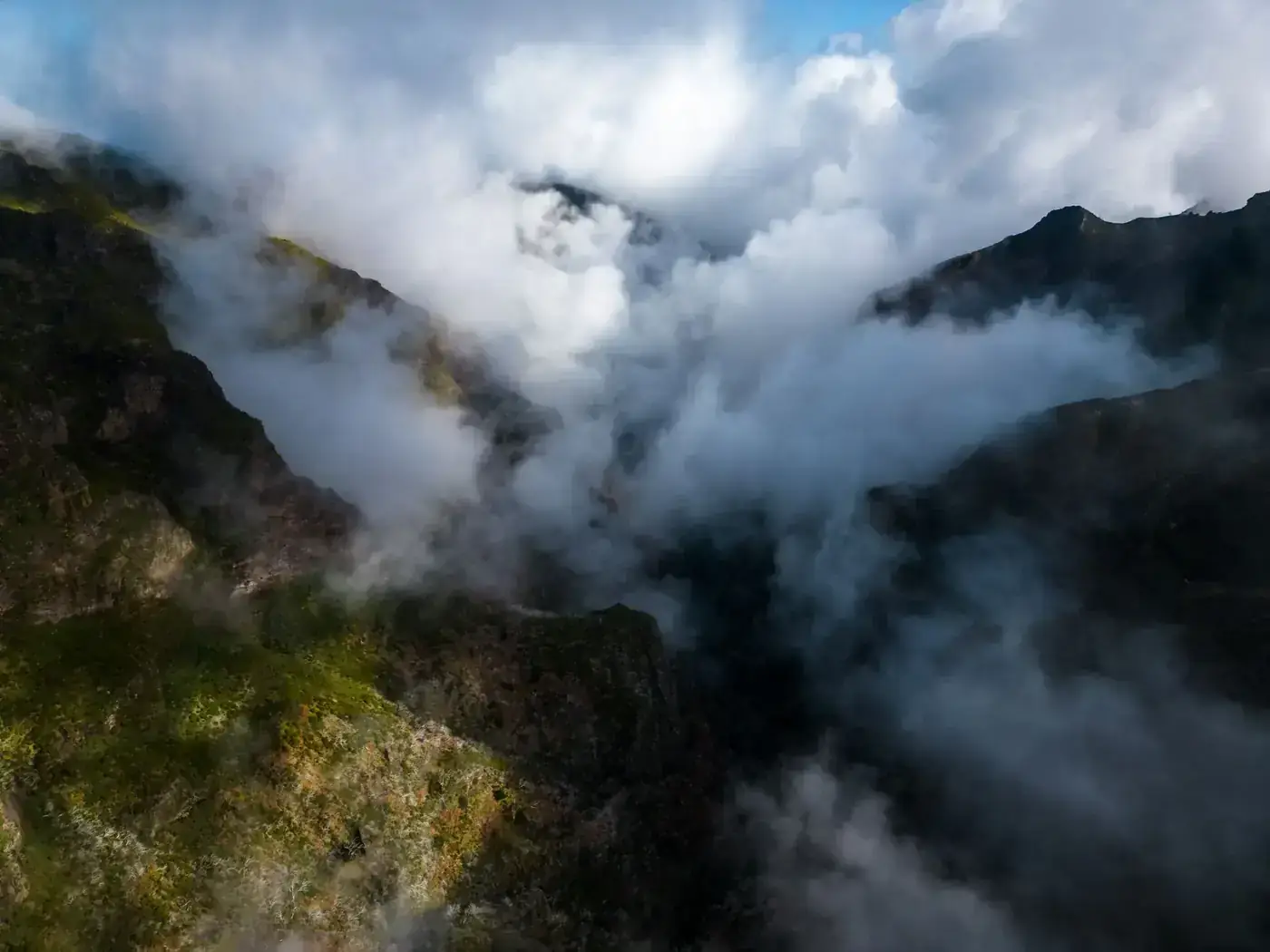 Aerial view of clouds enveloping the rugged mountains in Curral das Freiras, Madeira.