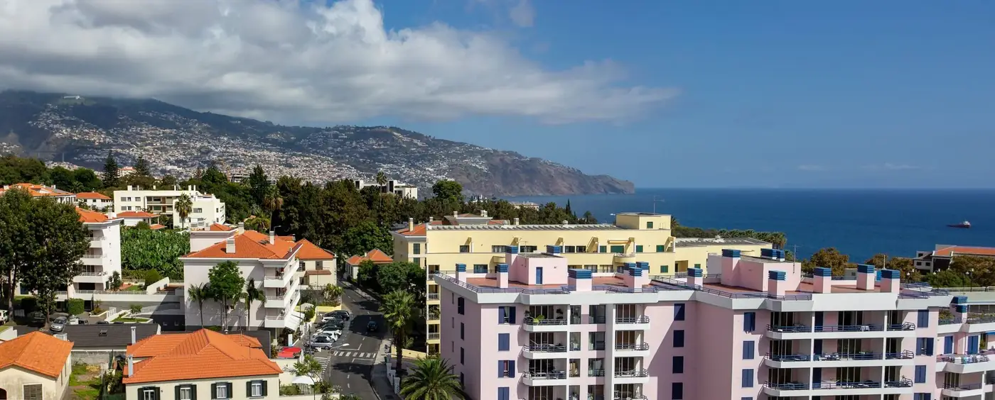 Aerial view of Funchal, Madeira showcasing vibrant coastal architecture with ocean backdrop.