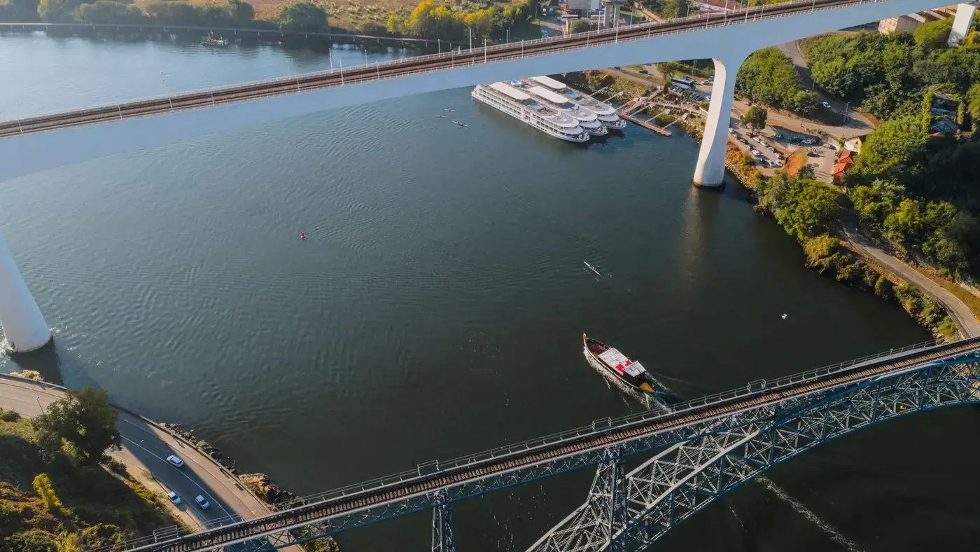 Drone shot of Porto, Portugal, showcasing the city's iconic bridges over the Douro River.