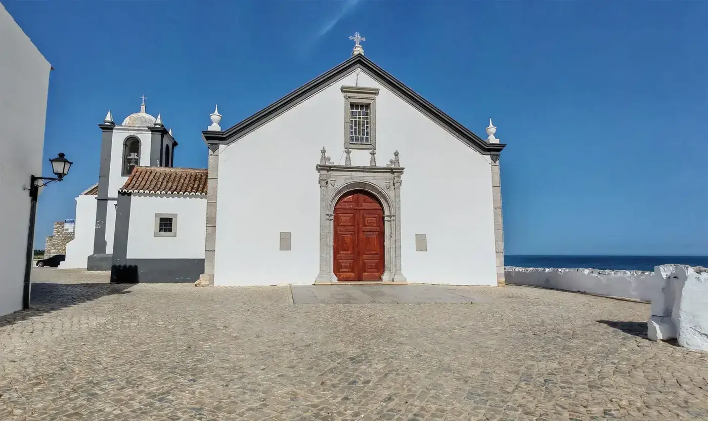 Beautiful historic church in Cacela Velha with ocean view, perfect for travel photography.
