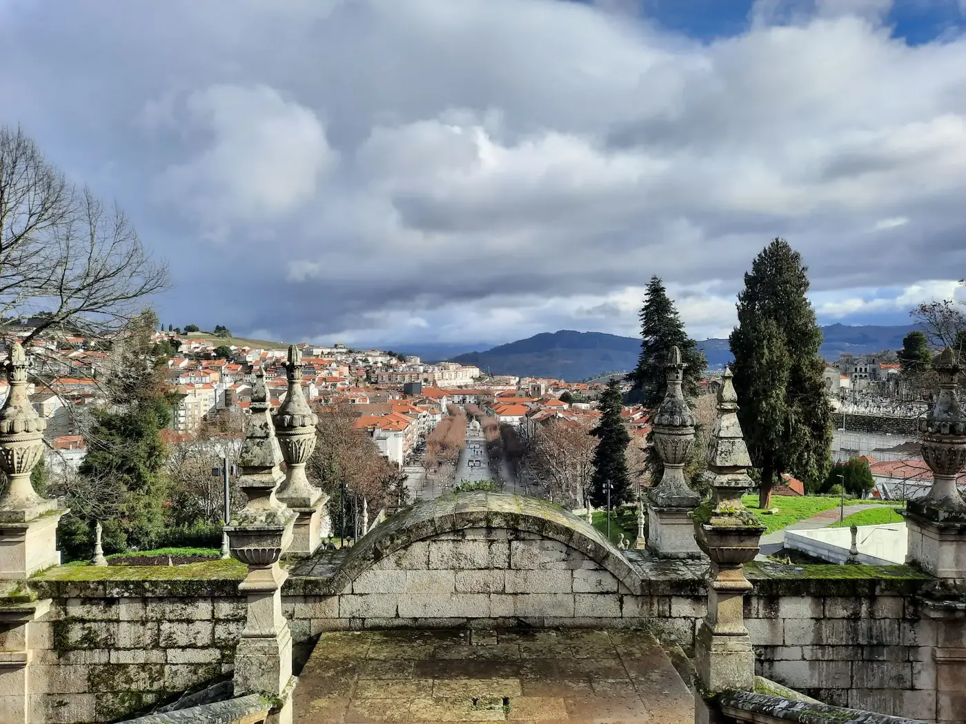 Captivating view of Lamego's red rooftops and distant mountains from the sanctuary steps.
